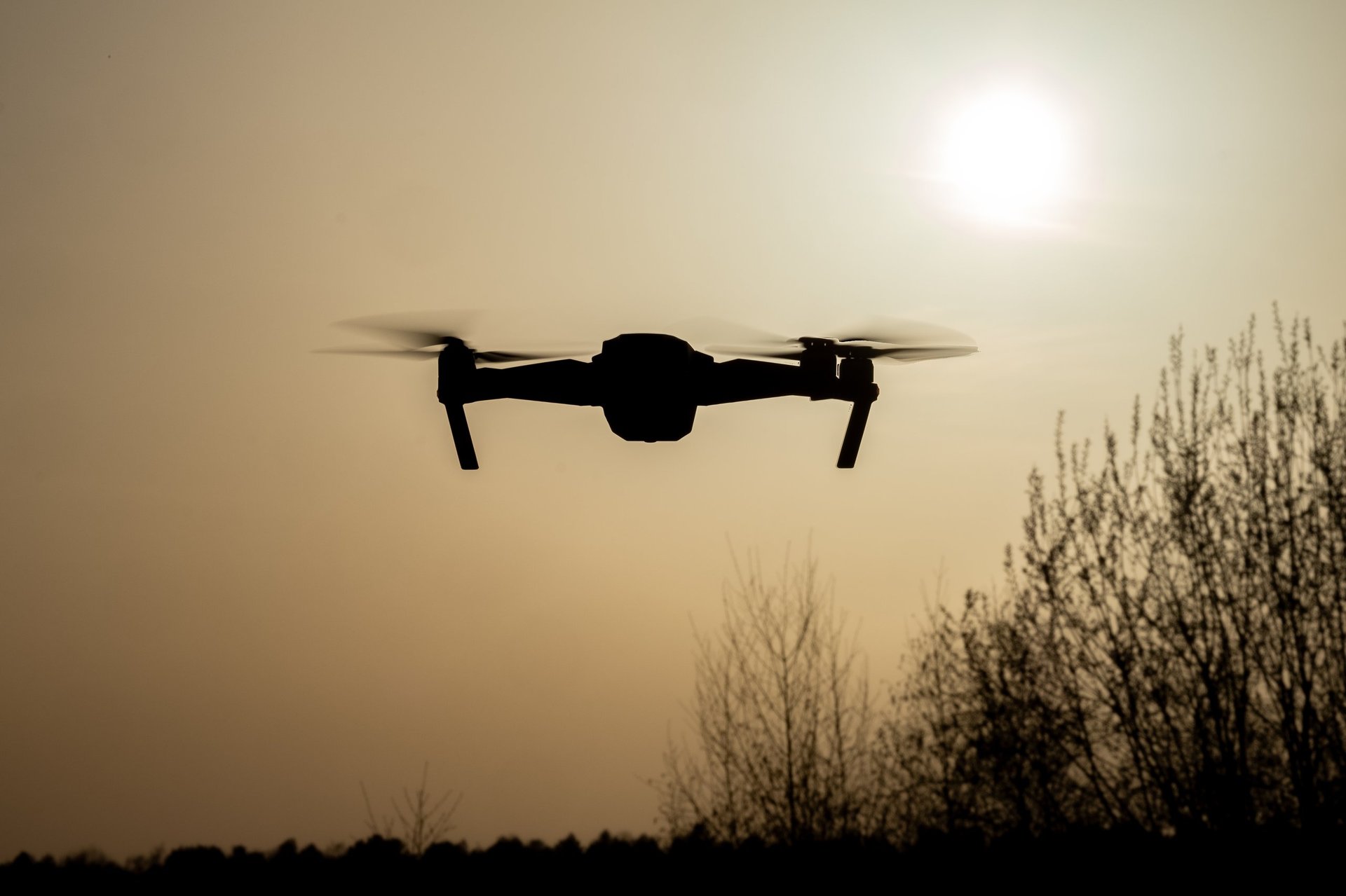 Drone soaring against beautiful sunset