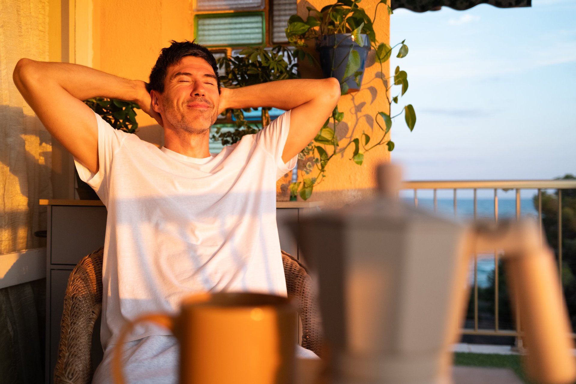 Person enjoying a peaceful sunset balcony view, representing the calm confidence our clients feel