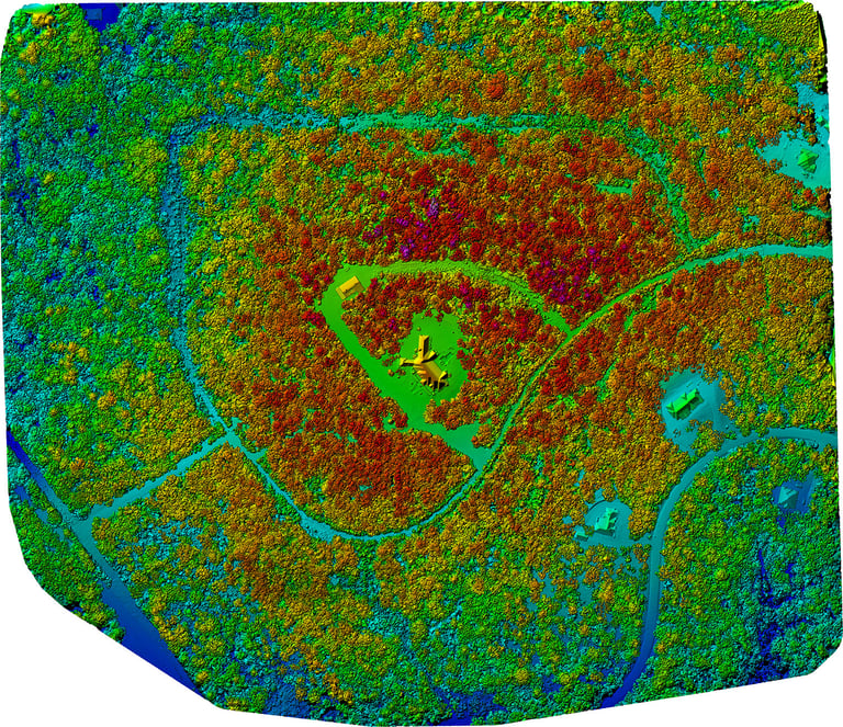 Aerial drone view of forested terrain with winding rivers and a cleared field marked with a green star indicating a location point